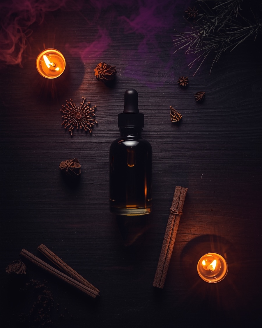 anointing oil for spiritual warfare with frankincense and cedarwood on dark wood surface for protection rituals